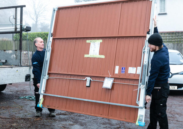 Engineers Carrying Garage Door