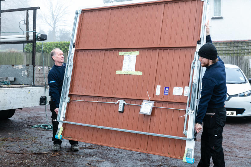 Engineers Carrying Garage Door