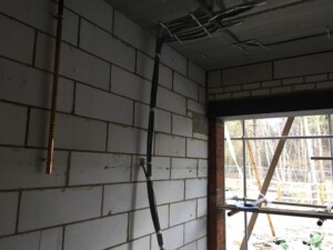 Garage interior with pipes and wiring attached to the walls