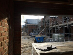 Looking out from a garage towards buildings