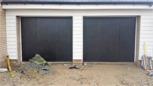 Black up and over steel ‘Thornby’ design garage doors by Novoferm